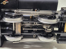 Close-up of black steam locomotive model mechanism with linked valve gear