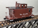 Brown side-view model caboose with Rio Grande 0575 marking, end ladders, and windows