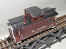 Brown and black-roof model caboose with Rio Grande lettering, side ladders, and roof hatch