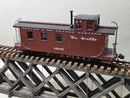 Burgundy Rio Grande Western caboose model, three-quarter view on display track.