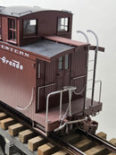 Burgundy caboose side with roof walkway and stairs, model on track.