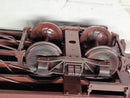 Caboose undercarriage and wheel close-up with metal mechanisms.