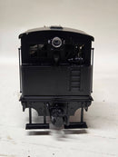 Pre-owned model steam locomotive, rear view with black tender and exposed coupler.